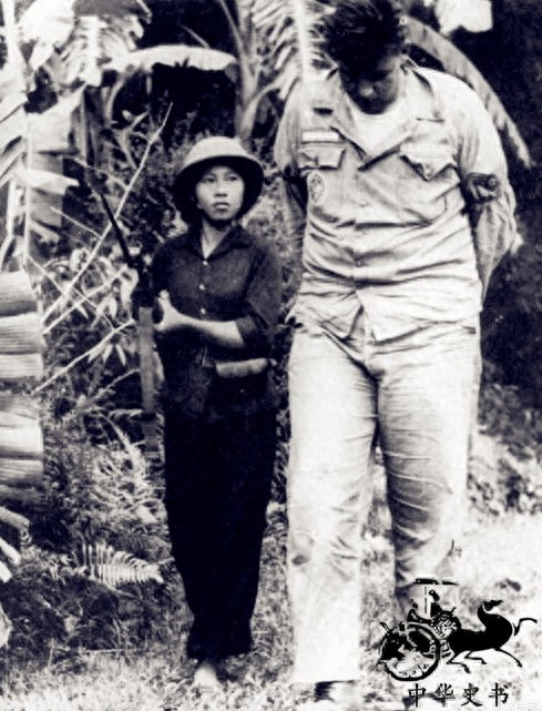 越战期间的越南女兵:图六双手反绑着,被美国大兵扛走